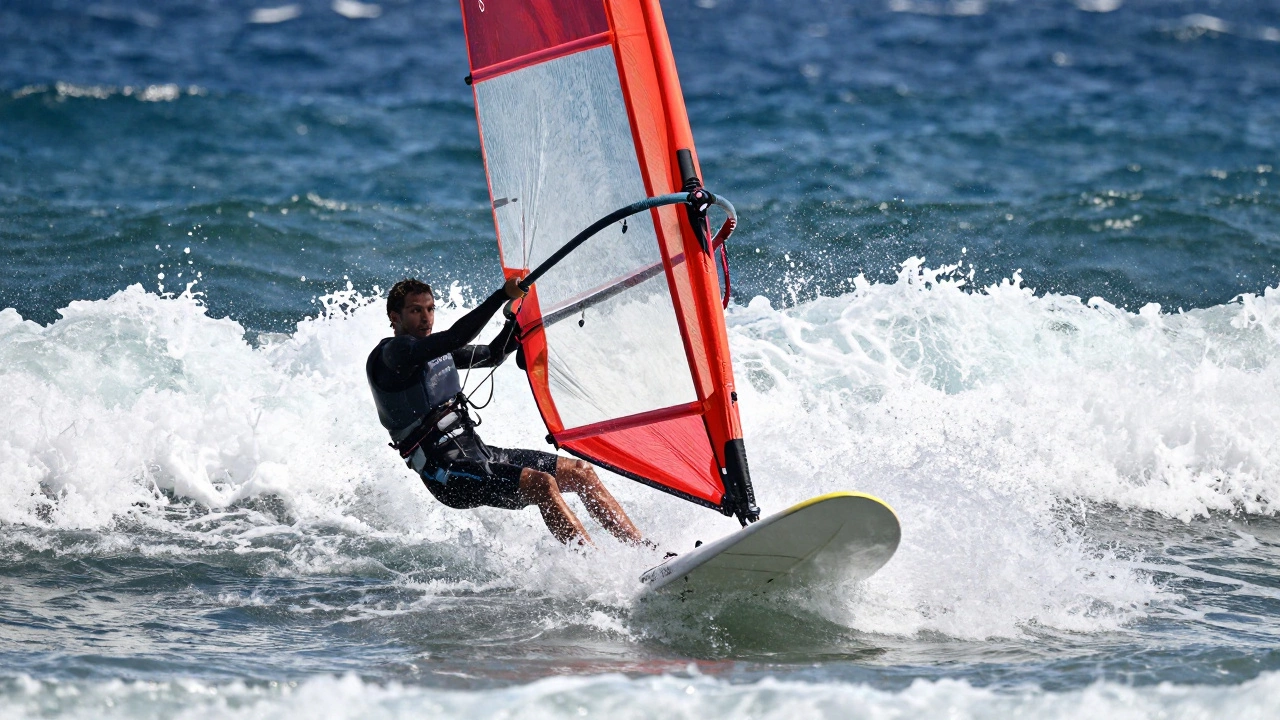 Windsurfer riding waves with a large sail